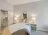 Inviting bedroom at 500 Park Avenue Apartments, showcasing a bed, dresser, and a lovely painting for a warm atmosphere.