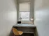 A small workspace with a laptop and chair in a cozy room at 500 Park Avenue Apartments.