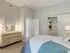 Cozy bedroom featuring a bed, dresser, mirror, and a stylish closet at 500 Park Avenue Apartments.