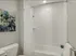 Chic bathroom in 500 Park Avenue Apartments, complete with a shower, toilet, and sink, perfect for relaxation.