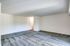 An unoccupied living room in Allyson Gardens Apartments, highlighted by soft carpet and pristine white walls.