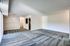 A vacant living room area in Allyson Gardens Apartments, highlighted by white walls and plush carpeting, perfect for styling.