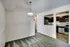 Bright kitchen and living room area at Allyson Gardens Apartments, highlighted by a modern light fixture.