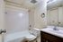 A clean bathroom in Allyson Gardens Apartments featuring a toilet, sink, and shower for a refreshing experience.