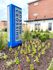 Boston Crossing Apartments sign stands proudly in front of a vibrant flower bed, welcoming residents and visitors alike.