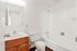 A cozy bathroom in Boston Crossing Apartments featuring a toilet, sink, and bathtub for a comfortable living experience.