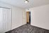 Cozy bedroom in Westview Commons Apartments featuring carpeted floors and elegant white doors.