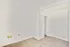 A welcoming, serene bedroom with pristine white walls, soft plush carpeting, a spacious closet for ample storage, and a charming doorway that adds to the room's cozy ambiance. Perfect for creating your personal retreat.