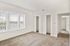 Bright and airy sunlit bedroom featuring expansive windows that flood the space with natural light. Enjoy ample storage with two generously sized closets, all within a stylish, modern apartment perfect for contemporary living.