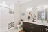 A well-designed bathroom at Lofts at Yard 56, showcasing a shower, toilet, and sink for convenient living.