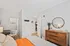 Cozy bedroom at Lofts at Yard 56 featuring a bed, dresser, and mirror for a stylish living space.