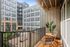 A welcoming balcony at Lofts at Yard 56, complete with chairs and a table for outdoor enjoyment.