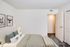 A stylish bedroom in Westview Commons Apartments with a bed, dresser, and two decorative pictures enhancing the space.