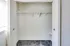 A bright bedroom closet with a white door, set against a soft gray carpet in Bright Meadows Townhomes.