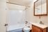 Bright Meadows Townhomes bathroom showcasing a clean toilet, sink, and shower in a well-lit space.