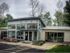 Bright Meadows Townhomes leasing office featuring a large parking lot and a car parked out front.