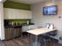 A bright kitchen in Bright Meadows Townhomes featuring a refrigerator, microwave, and a television for entertainment.