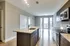 A modern kitchen featuring granite countertops, stainless steel appliances, and a large island with a sink.