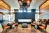 A sophisticated lounge with contemporary seating, a central fireplace, and a stunning modern design.