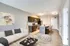 Bright and airy open-concept living area with a modern kitchen and cozy seating.