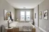 A stylish bedroom with contemporary decor, featuring a minimalist bed, abstract artwork, and ambient lighting.