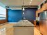 Stylish kitchen with blue walls and wooden floors, featuring a beautiful island at Lancaster Lofts.