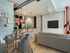 A stylish modern apartment featuring a kitchen, dining area, and a furnished living room in Lancaster Lofts.