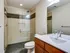 Stylish bathroom at Lancaster Lofts showcasing a shower stall and toilet, perfect for a refreshing experience.