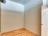 A spacious empty bedroom in Lancaster Lofts featuring hardwood floors and a single door.