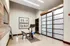 A sleek home gym with a contemporary exercise bike, refined decor, and a roomy layout.