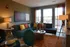 A comfortable urban living room with chic decor, showcasing a spacious sectional sofa, soft lighting, and contemporary artwork.