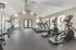 The fitness center at Hampton Point Apartments showcases exercise equipment and windows, creating a vibrant workout space.