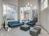 A bright modern lounge area at 500 Park Avenue Apartments featuring large windows and a cozy couch.