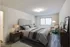 A well-organized bedroom in Allyson Gardens Apartments, complete with a bed, desk, and nightstand for a serene environment.