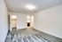 Open empty room with gray carpet and white walls, ready for your touch at Allyson Gardens Apartments.