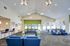 A bright and welcoming lobby at the new community center, featuring cozy seating and vibrant decor.