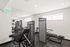 Exercise equipment and a mirror in the gym room of Boston Crossing Apartments, perfect for fitness enthusiasts.