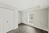 Inviting entryway with large window, modern flooring, and double-door closet.