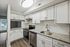 Sleek contemporary kitchen with granite countertops and white cabinetry.