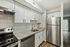 Sleek modern kitchen with stainless steel appliances, granite countertops, and white cabinetry.