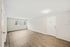 Bright and airy modern living room with wood flooring and a large window.