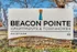 Beacon Pointe Apartments & Townhomes sign with contact information displayed.