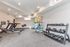 Sleek home gym equipped with treadmills, a set of dumbbells, and a variety of fitness gear.
