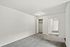 A bright, empty dining space with plus gray carpeting and a spacious closet perfect for personal items.