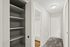 A bright hallway with built-in shelving, carpeted flooring, and modern lighting, creating a functional and stylish space.