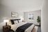 A bright and modern bedroom with a plus bed, stylish decor, and natural light to create an open space room.
