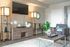 Elegant and cozy living room with modern furnishings, featuring a stylish TV setup and decorative accents.
