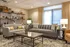 Inviting living room with modern gray sofas, a glass coffee table, and warm ambient lighting.