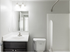 A bright and modern bathroom with a contemporary sink, sleek vanity, and a pristine white shower, creating a fresh and stylish look.