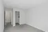 A bright unfurnished bedroom with plush gray carpeting and a spacious walk-in closet at Catons Villas North.